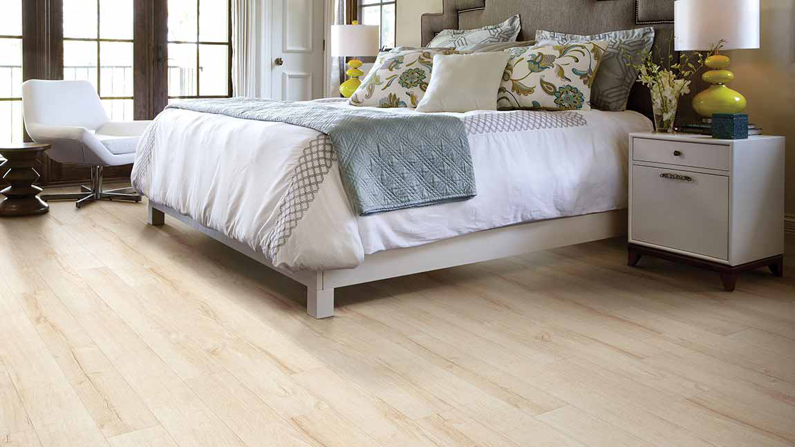 Light oak shade of laminate floor in bedroom scene